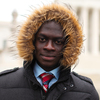 Tarkpor Mambia in front of the Supreme Court in Washington, D.C. He says he "literally froze" during his first American winter in 2013, but is getting used to the cold weather.