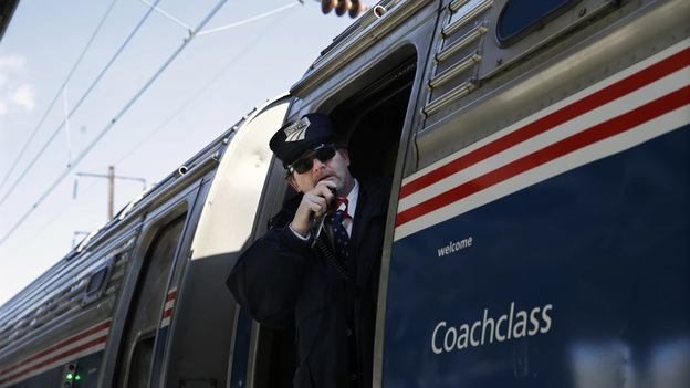 Amtrak conductor Michael Laubauskas talks on a radio Feb. 19 as his train departs Trenton, N.J., for Washington, D.C. The U.S. House passed an Amtrak funding bill Wednesday that splits Amtrak's high-ridership Northeast Corridor line that runs from Boston to Washington from the less profitable part of the system. (AP)