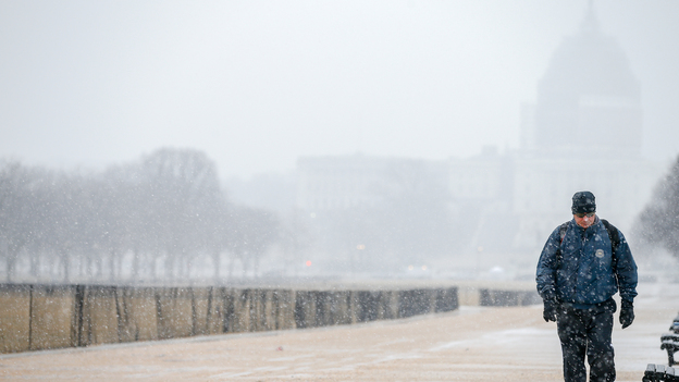 Snow begins to fall along the National Mall, in Washington, Thursday morning. The federal government closed its offices because of a new round of winter weather expected in the region. (AP)