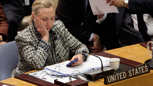 U.S. Secretary of State Hillary Rodham Clinton checks her mobile phone in March 2012 after her address to the Security Council at United Nations headquarters. While she's asked the State Department to quickly release her emails from her tenure as secretary, the process likely will take months — dragging out media coverage and critical questions. (AP)
