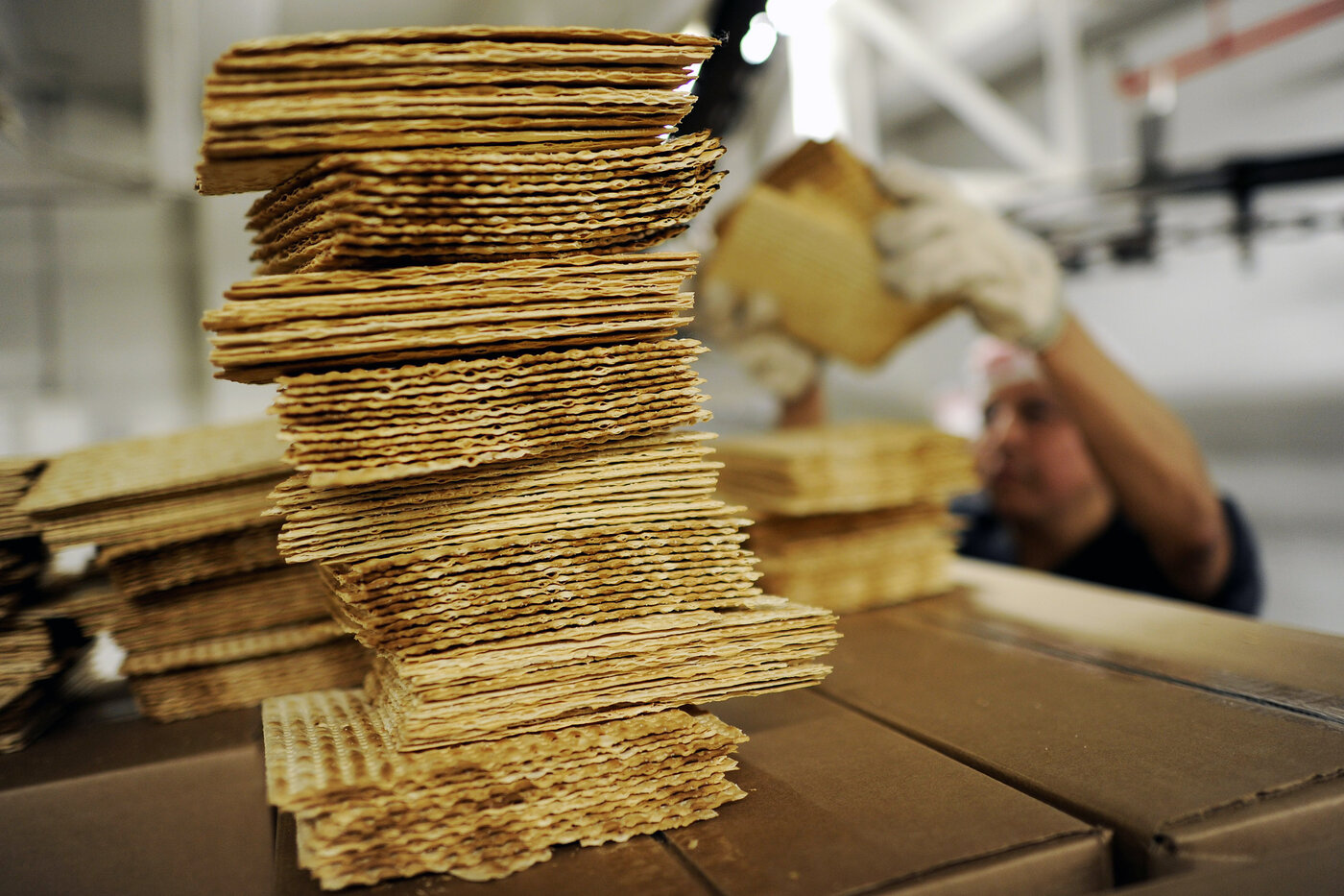 A worker stacks matzo wafers at Streit's matzo factory on the Lower East Side of New York in 2012. A worker stacks matzo wafers at Streit's matzo factory on the Lower East Side of New York in 2012.