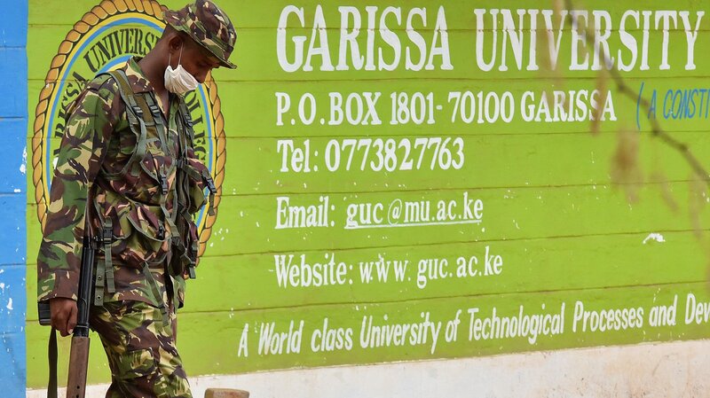 A Kenya soldier walks past the front entrance of Garissa University Friday. Kenya's interior minister vowed that the country would not bow to terrorist threats, a day after the massacre of 147 students.