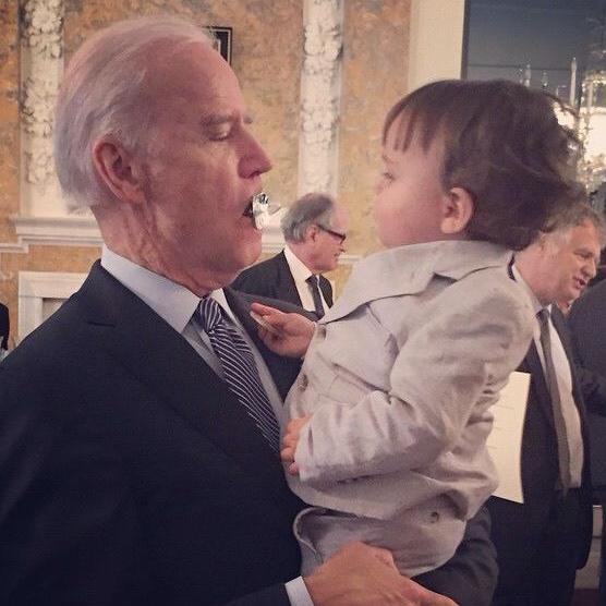 Joe Biden takes Jasper Bloomberg's pacifier.