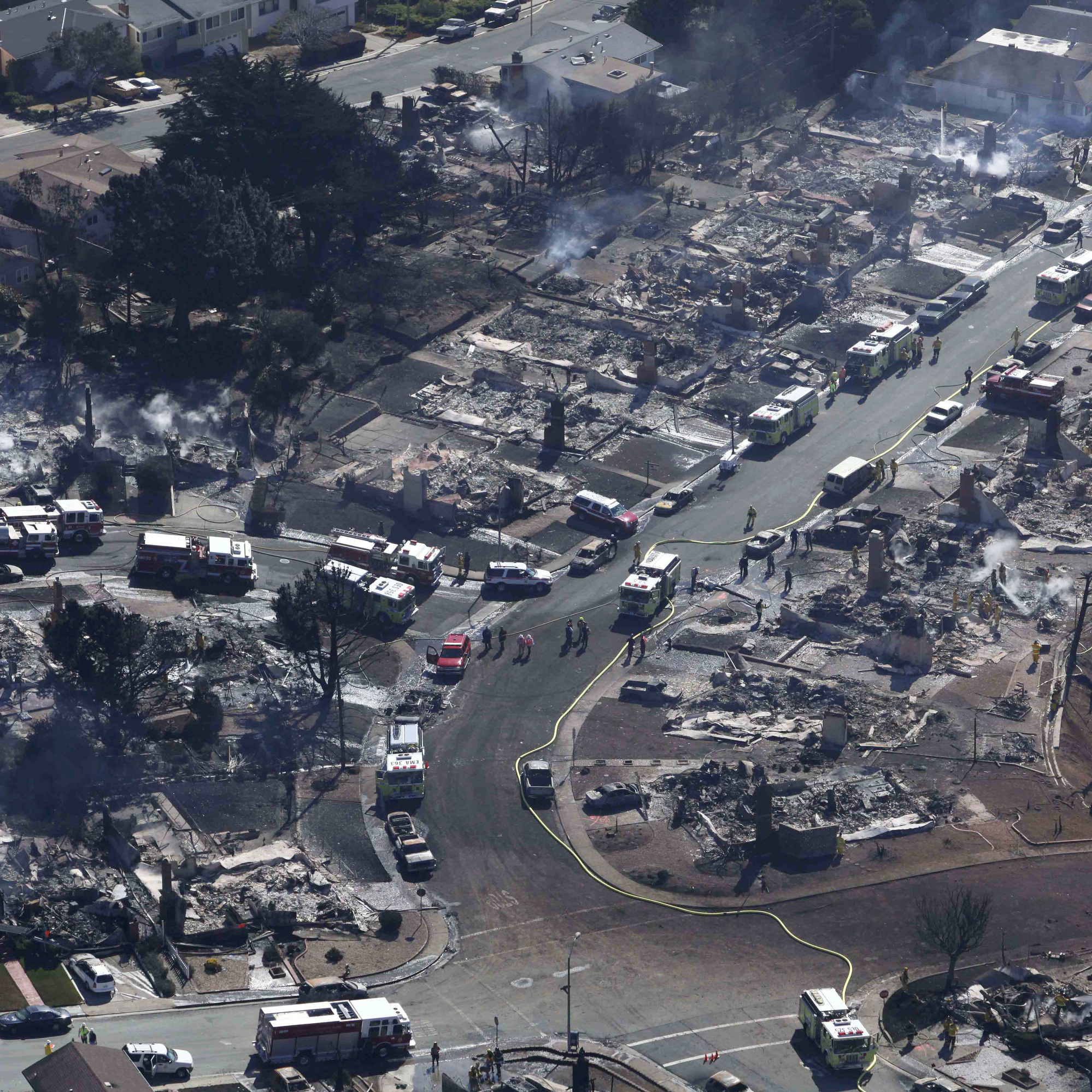 A Sept. 10, 2010 photo showing firefighters and rescue crews working amid damage caused by the pipeline explosion in San Bruno, Calif.