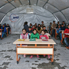 Syrian children listen to a teacher during a lesson in a temporary classroom in Suruc refugee camp on March 25 in Suruc, Turkey. The camp is the largest of its kind in Turkey with a population of about 35,000 Syrians who have fled the ongoing civil war in their country.