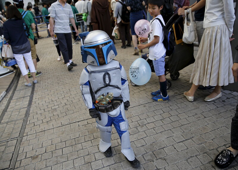A celebrant dressed up as Jango Fett walks at a Star Wars Day fan event in Tokyo Monday.