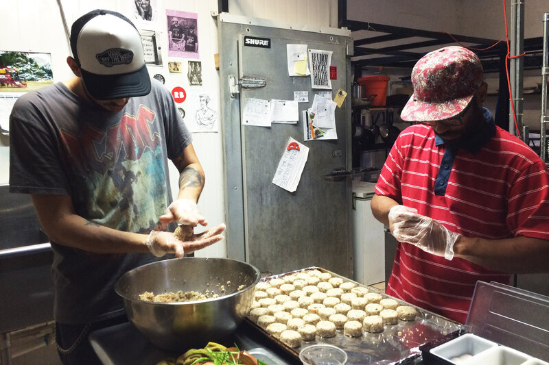 Roberto Diaz and Manuel Vasquez prepare croquettes made from green bananas and quinoa in the kitchen of El Departamento de la Comida, a farmers market and restaurant in San Juan.