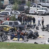 Authorities investigate a shooting in the parking lot of the Twin Peaks restaurant Sunday in Waco, Texas. Authorities say the shootout victims were members of rival biker gangs that had gathered for a meeting. Authorities investigate a shooting in the parking lot of the Twin Peaks restaurant Sunday in Waco, Texas. Authorities say the shootout victims were members of rival biker gangs that had gathered for a meeting.