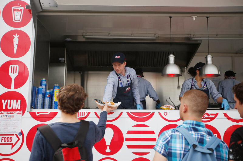 A man serves hamburgers at the USA Pavilion's food truck at Expo 2015 in Rho, near Milan, Italy. The Food Truck Nation exhibit highlights America's urban food truck trend. A man serves hamburgers at the USA Pavilion's food truck at Expo 2015 in Rho, near Milan, Italy. The Food Truck Nation exhibit highlights America's urban food truck trend.