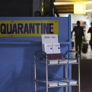In this photo from 2014, passengers walk past the Middle East respiratory syndrome quarantine area at Manila's International Airport in the Phillipines. The virus is now raising public concern in South Korea.