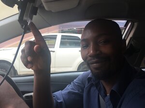 One of Uber's Nairobi drivers, Jackson Kamau, points proudly to an iPhone that shows his high rating. One of Uber's Nairobi drivers, Jackson Kamau, points proudly to an iPhone that shows his high rating.