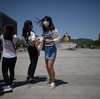 A student wearing a face mask stands in a public square in Seoul on June 3. More than 200 primary schools shut down as South Korea has struggled to contain an outbreak of the MERS virus.