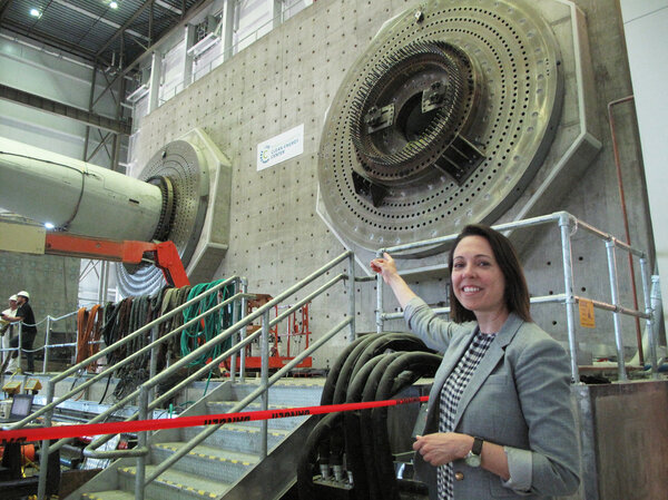 Alicia Barton is the CEO of the Massachusetts Clean Energy Center. She's pointing at the massive steel and cement structure that supports the 100- to 200-foot-long blades at the testing center. Barton says the mission of this facility is "to advance the state of wind energy technology in a way that will help that technology become more cost-effective over time."