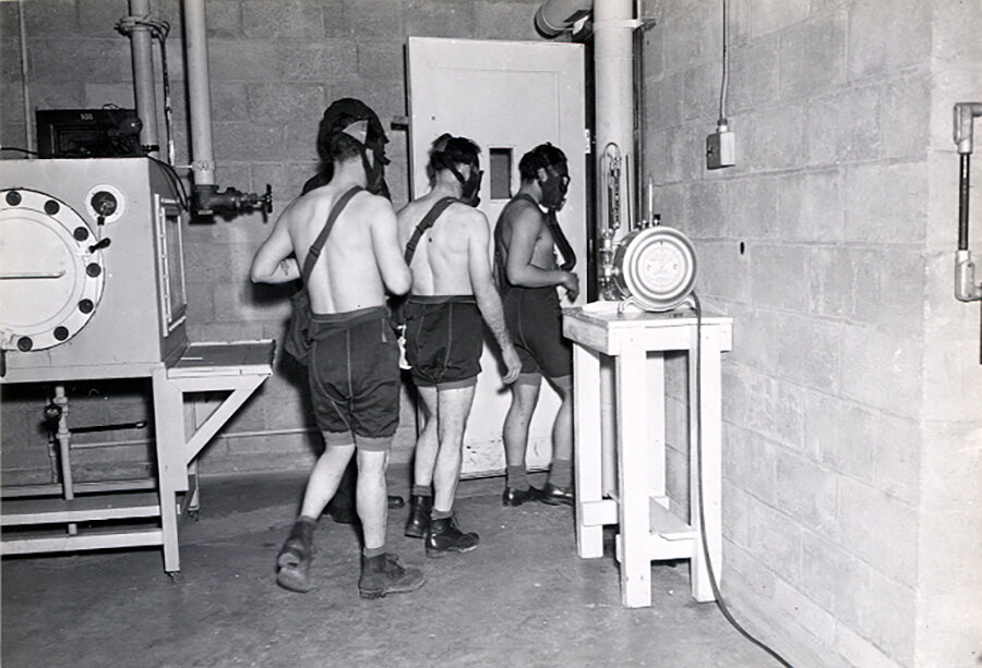 Three test subjects enter a gas chamber, which will fill with mustard gas, as part of the military's secret chemical warfare testing in March 1945.
Courtesy of Edgewood Arsenal