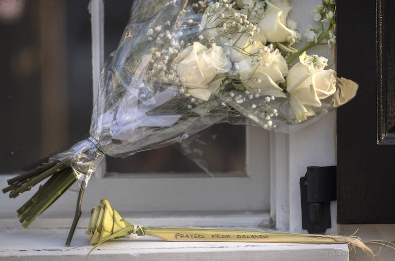 A palm rose with a message from Orlando, Fla., is placed near the front of the Emanuel AME Church just days after the shooting.