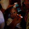 At the health clinic in Minjibir, Nigeria, a child is immunized for polio.