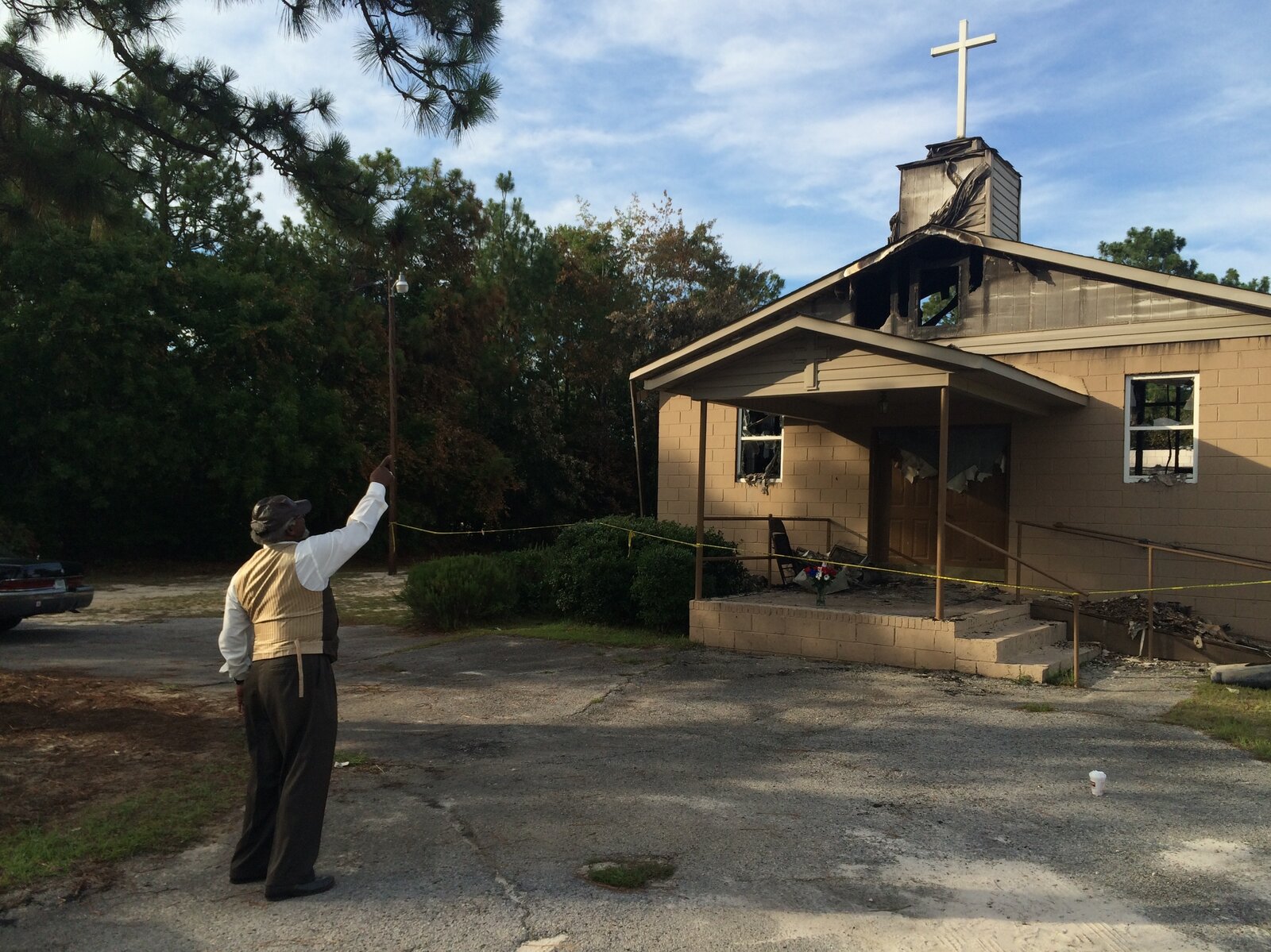 Pastor Bobby Jones points to the cross on top of Glover Grove Baptist Church in Warrenville, S.C., where he has preached for more than 30 years. The steeple was one of the only parts of the church left standing. Pastor Bobby Jones points to the cross on top of Glover Grove Baptist Church in Warrenville, S.C., where he has preached for more than 30 years. The steeple was one of the only parts of the church left standing.