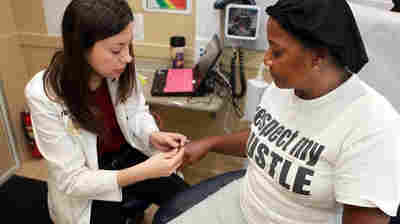 Dr. Annelys Hernandez checks out Cynthia Louis in Florida International University's Mobile Health Center in March.