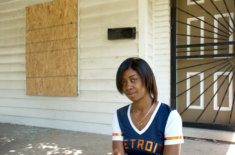 Lanita Carter sits on the porch of the home she purchased in Detroit. Lanita Carter sits on the porch of the home she purchased in Detroit.