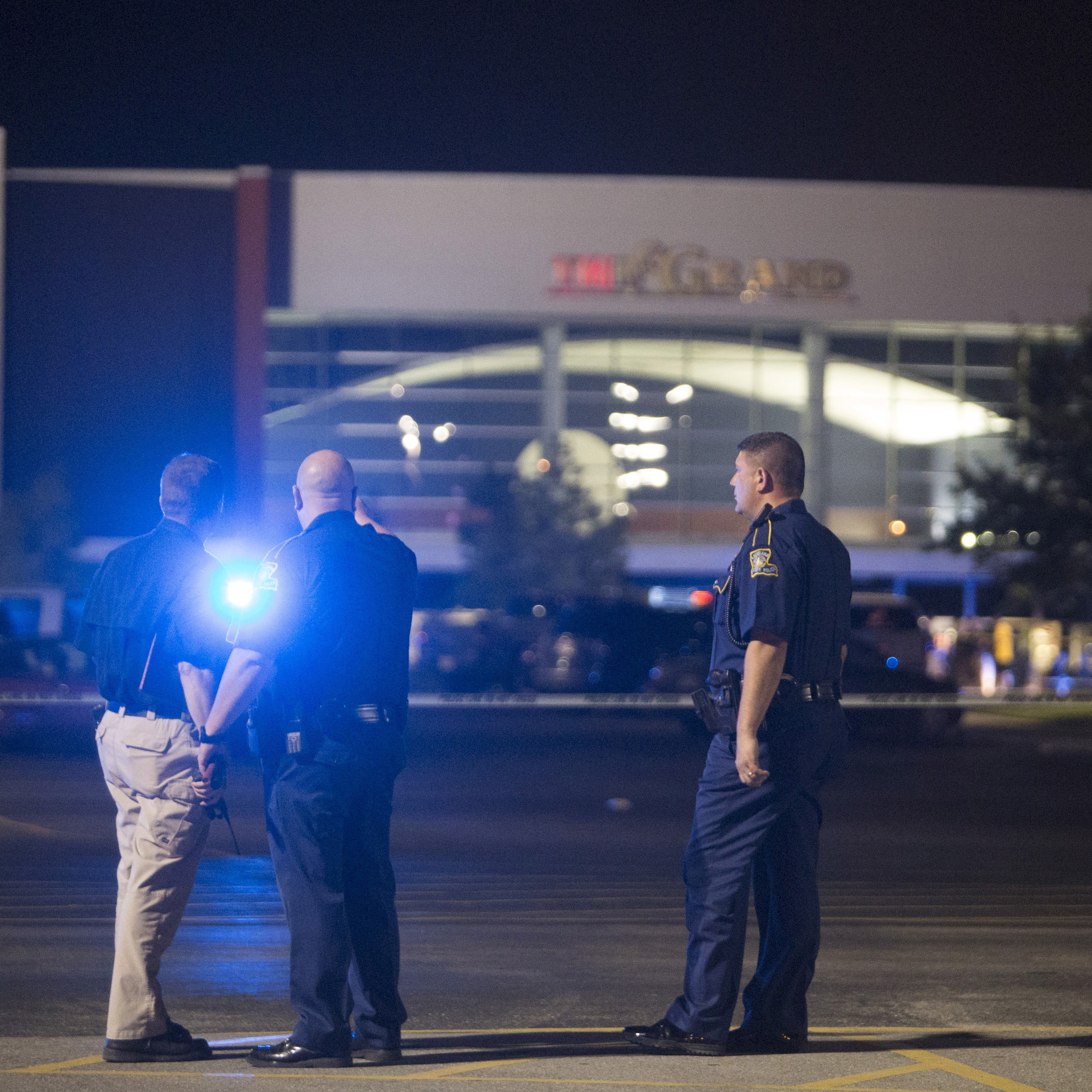 Officials stand by the scene outside a movie theater where a man opened fire on filmgoers Thursday in Lafayette, La. At least two were fatally wounded and seven others injured before the gunman killed himself.