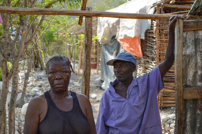 Charlesina Lyone and her husband stand in the shell of their new house in Tete de l'eau, Haiti.