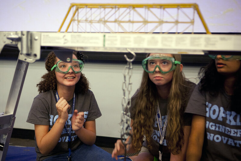 Sheidey Morales Del Valle (left), Amelia Hawley and Varsha Gopal of Team Foxy Epoxy try sending their bridge subliminal messages, willing it to hold up under pressure. Sheidey Morales Del Valle (left), Amelia Hawley and Varsha Gopal of Team Foxy Epoxy try sending their bridge subliminal messages, willing it to hold up under pressure.
