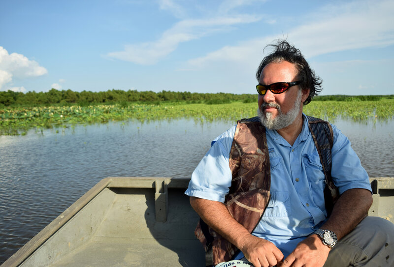 John Lopez, director of coastal sustainability for the Lake Pontchartrain Basin Foundation, looks out at the Caernarvon river diversion. The structure diverts freshwater from the Mississippi River into the Breton Basin, helping to restore a balance with saltwater from the Gulf of Mexico.