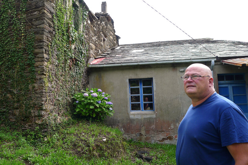 Mark Adkinson, a Briton who lives in Spain, runs a real estate agency selling abandoned villages and other historic properties. Here Adkinson stands amid buildings for sale in the abandoned village of O Penso.