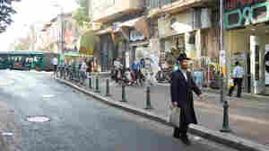 In the ultra-Orthodox Jewish neighborhood of Mea Sharim, men wear dark pants, long dark coats and black hats.