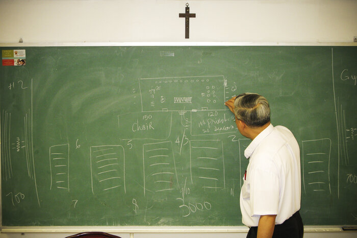 The Rev. Joseph Trinh, the senior priest at St. Helena, meets with the liturgy and decorations committee planning a Mass for Vietnamese Catholics during Pope Francis' visits to the city later this month. (Tom Gjelten/NPR) The Rev. Joseph Trinh, the senior priest at St. Helena, meets with the liturgy and decorations committee planning a Mass for Vietnamese Catholics during Pope Francis' visits to the city later this month.