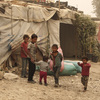 Syrian refugees stand outside their tents during a sandstorm in a refugee camp in the town of Bar Elias, in Lebanon's Bekaa Valley. Syrian refugees stand outside their tents during a sandstorm in a refugee camp in the town of Bar Elias, in Lebanon's Bekaa Valley.