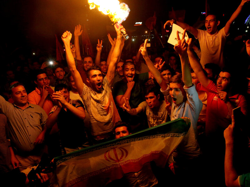 Iranians cheer during street celebrations July 14 in Tehran, Iran, following a landmark nuclear deal. Many young Iranians want their country to open to the world, and see the nuclear agreement as an important step in ending Iran's isolation. (Ebrahim Noroozi/AP)