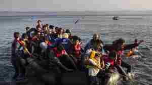 Migrants from Syria and Afghanistan arrive on an overcrowded dinghy from the Turkish coasts to the Greek island of Lesbos, Monday, July 27, 2015.