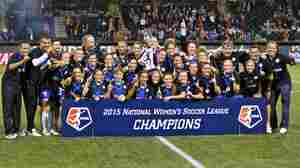 FC Kansas City pose with the trophy after the NWSL soccer championship match in Portland, Ore., on Oct. 1. Deford's commentary was corrected to include information about the NWSL, the top professional women's soccer league in the U.S.