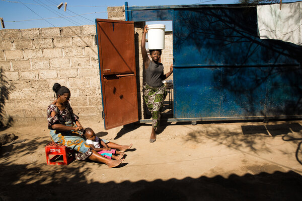 Mulando fetches water from a tap a short walk from her home. Most Zambian schoolgirls have to advocate for their interests in a way that American high schoolers rarely need to, says Kathleen McGinn, a professor of negotiation at Harvard Business School. (Samantha Reinders for NPR)