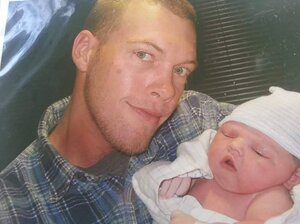 Billy Doyle Walker with his daughter Kaylee on the day she was born. Four months later he died after falling from a tower he was painting. The opt-out plan his employer uses provided his family with only a quarter of the benefits they may have received under the state's workers' compensation law. (Courtesy of Krystle Meloy)