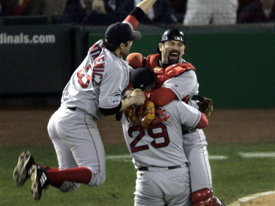 Boston Red Sox's Doug Mientkiewicz, left, and catcher Jason Varitek, right, jump into Keith Foulke's arms after the Red Sox defeated the St. Louis Caridnals 3-0 in Game 4 to win the 2004 World Series. (Sue Ogrocki/AP)