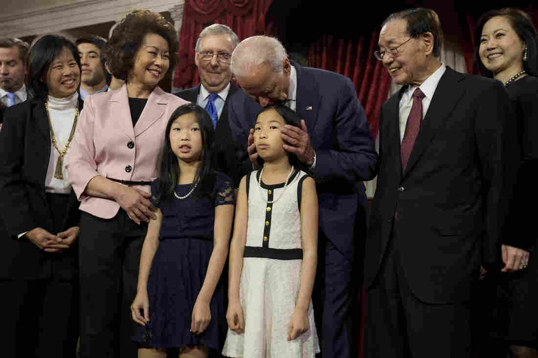 Biden kisses a niece of Senate Majority Leader Mitch McConnell, R-Ky., during a ceremonial Senate swearing-in ceremony on Capitol Hill in 2015.