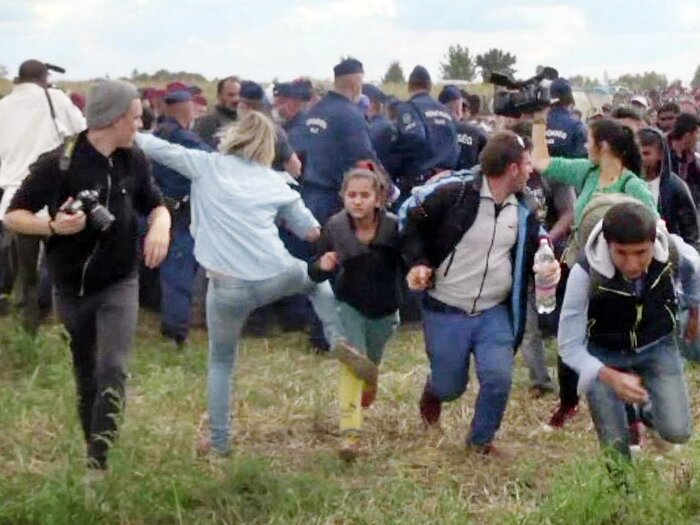 This video grab made on early September shows a Hungarian TV camerawoman kicking a child as she runs with other migrants from a police line during disturbances at Röszke, southern Hungary. (AFP/Getty Images)