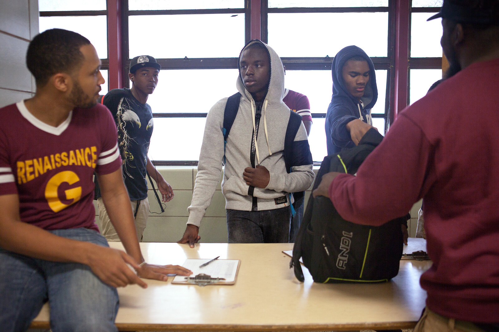 Taylor (left) greets student Kyree McRae, 16, as he checks into morning classes. Taylor (left) greets student Kyree McRae, 16, as he checks into morning classes.