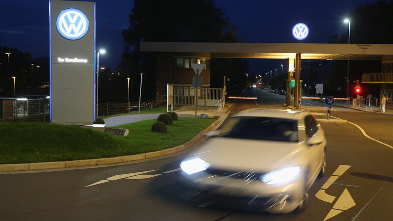 Volkswagen says the fallout from its diesel emissions scandal is still becoming clear, as it reports a large quarterly loss. A car departs from Volkswagen's factory and company headquarters in Wolfsburg, Germany. (Sean Gallup/Getty Images)