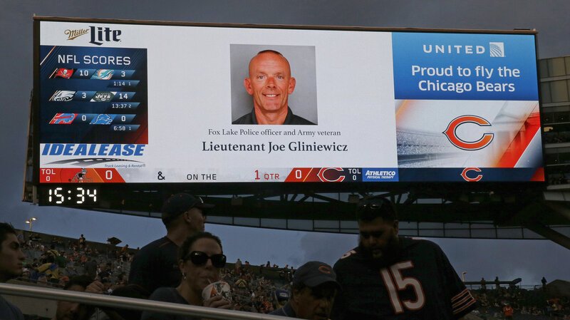 The late Fox Lake Police officer Lt. Charles Joseph Gliniewicz is displayed on a scoreboard during the first half of an NFL preseason football game between the Chicago Bears and the Cleveland Browns, on Sept. 3, 2015, in Chicago. (Nam Y. Huh/AP)