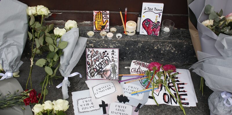 Impromptu memorials for the victims of Friday's terrorist attacks have been started all over Paris. Some mourners express both sorrow for the dead and concern over a potential backlash against French Muslims. (Olivier Corsan/Maxppp /Landov)