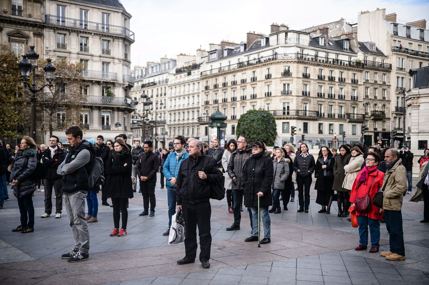 People gather to hold a minute of silence in front of the Paris city Hall, France, on Monday. (Christophe Petit Tesson /EPA /LANDOV)