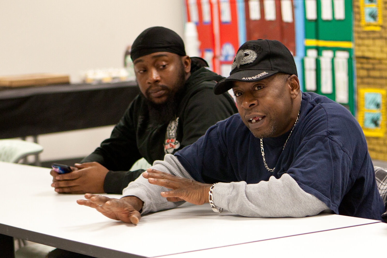 Harrelle Felipa, right, speaks during the Responsible Fathers meeting at the Center for Urban Families in Baltimore. His child support debt has accrued to $20,000 after he quit a job to be a stay-at-home dad. (Jun Tsuboike/NPR)