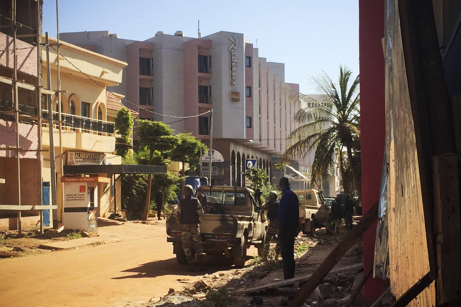 Malian troops take position outside the hotel in Bamako. (Sebastien Rieussec/AFP/Getty Images) Malian troops take position outside the hotel in Bamako.