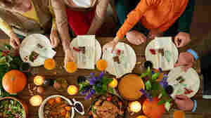 A family sits down to Thanksgiving dinner.