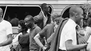 An unidentified Freedom Rider sticks his head out of a chartered bus window in Jackson, Miss., in August 1961.