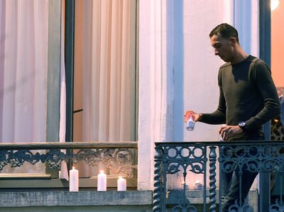 Mohamed Abdeslam places candles on a window ledge of his family's apartment Nov. 18 during a candlelight vigil in Brussels' Molenbeek district town square. Two of his brothers were among the attackers in Paris on Nov. 13. (Emmanuel Dunand/AFP/Getty Images)