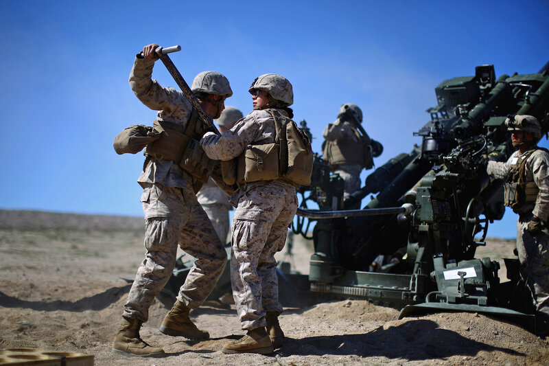 Pentagon chief Ash Carter is expected to announce that women can now serve in front-line combat posts. Here Carolina Ortiz moves away from a 155 mm artillery piece after loading it during a live-fire exercise at the Marine base in Twentynine Palms, Calif., earlier this year, in a months-long study of how women might perform in ground combat jobs. (David Gilkey/NPR)